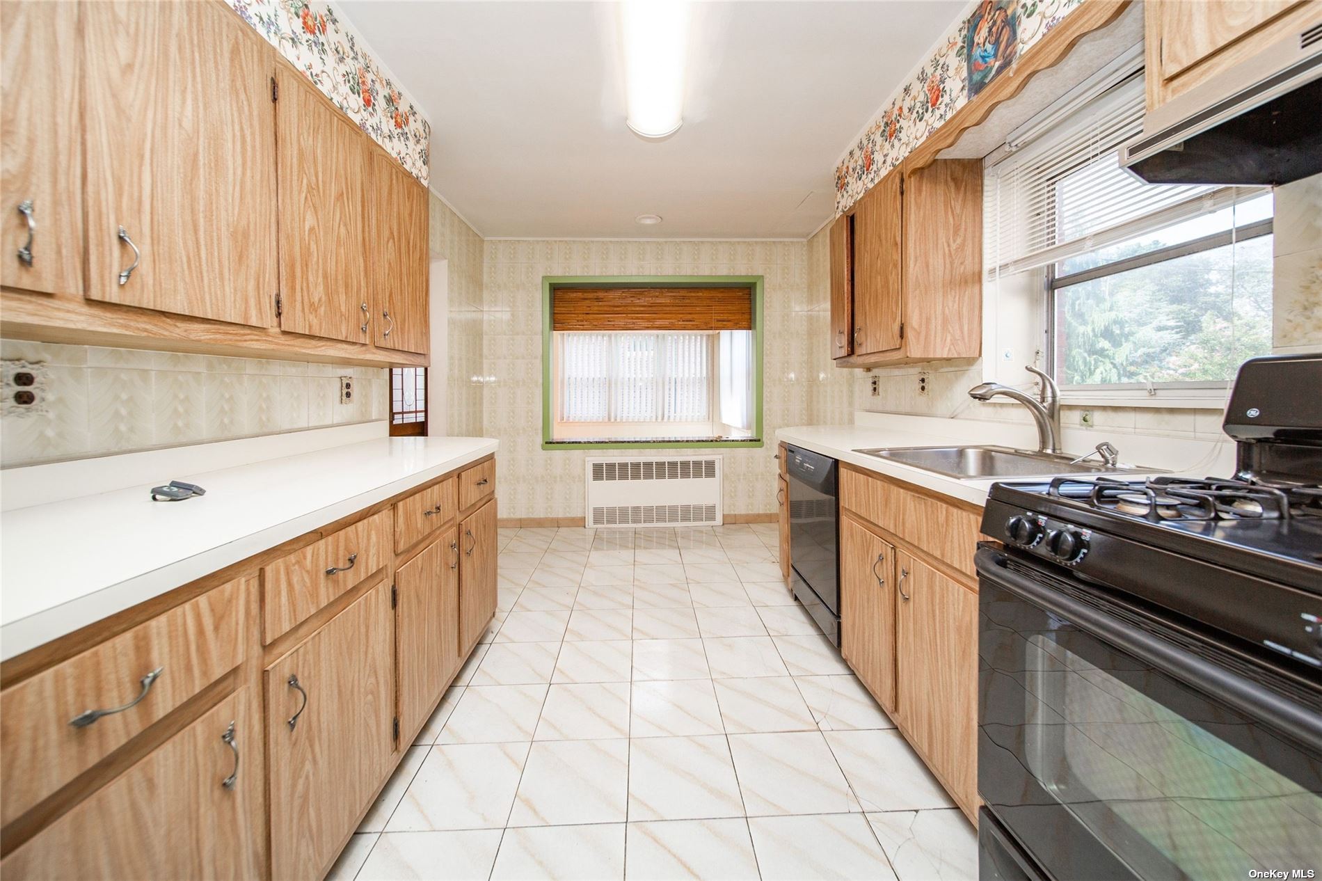 2-06 147th Place Queens, NY 11357 - Photo 6 of 21 a kitchen with a sink stove and cabinets
