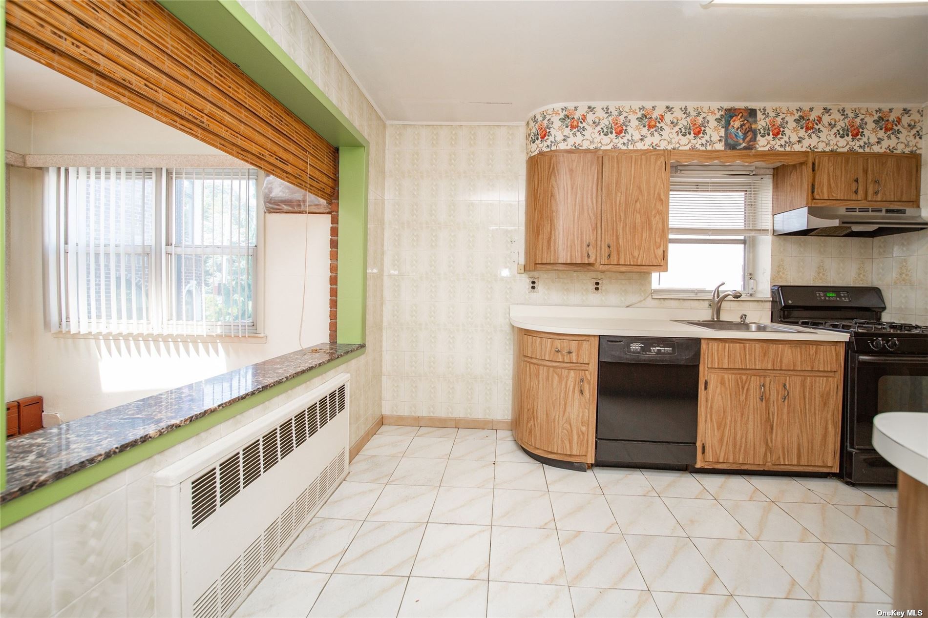 2-06 147th Place Queens, NY 11357 - Photo 7 of 21 a kitchen with stainless steel appliances a stove and a sink
