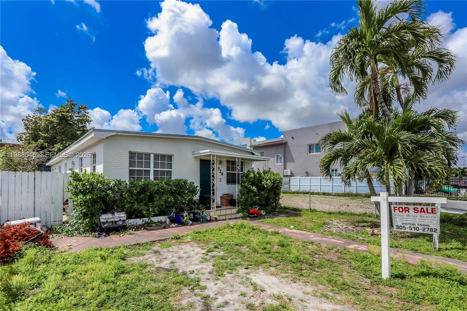 528 East 10th Street Hialeah, FL 33010 - Photo 1 of 13 a front view of a house with garden