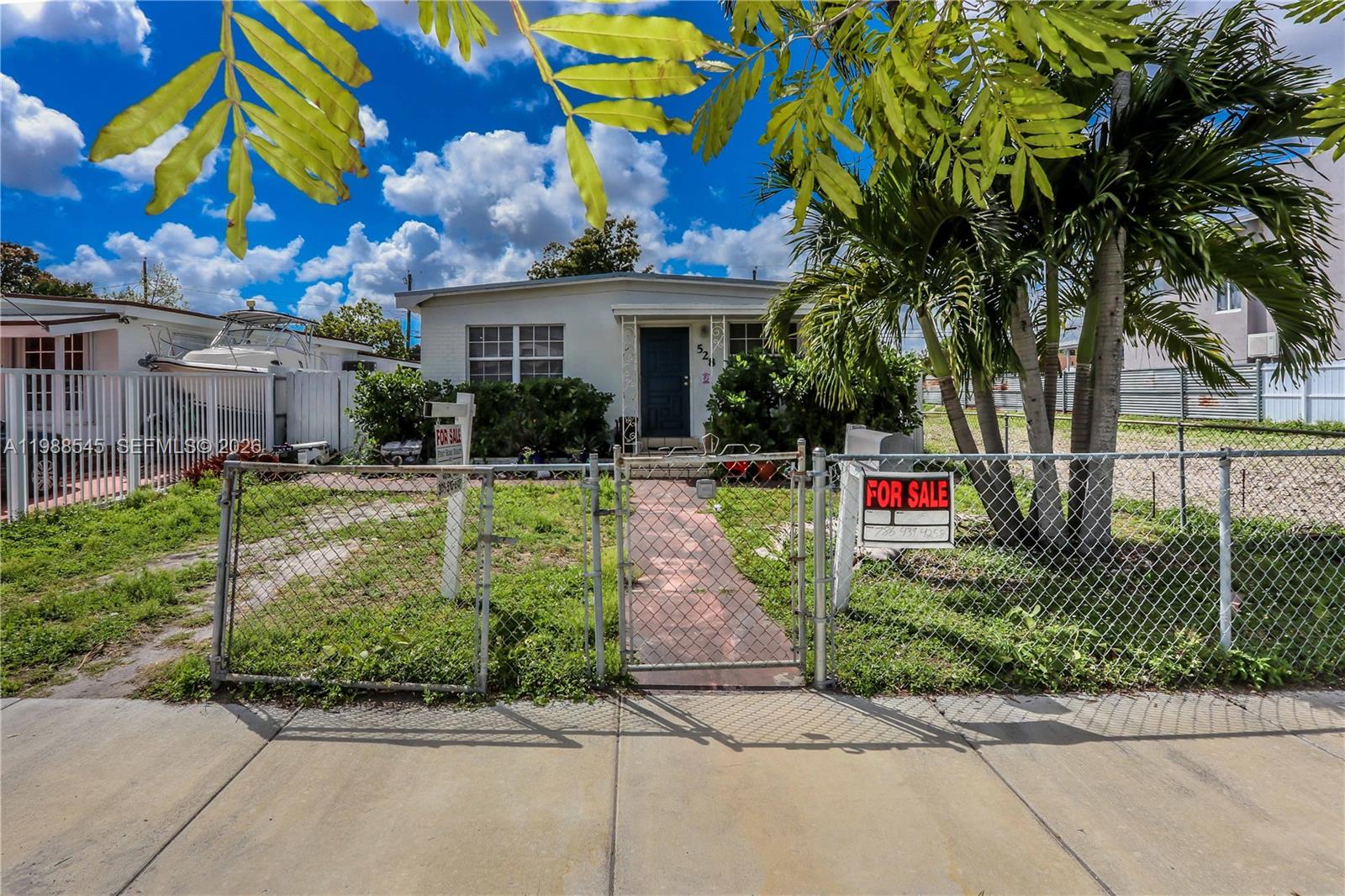 528 East 10th Street Hialeah, FL 33010 - Photo 2 of 13 a front view of a house with a yard and potted plants