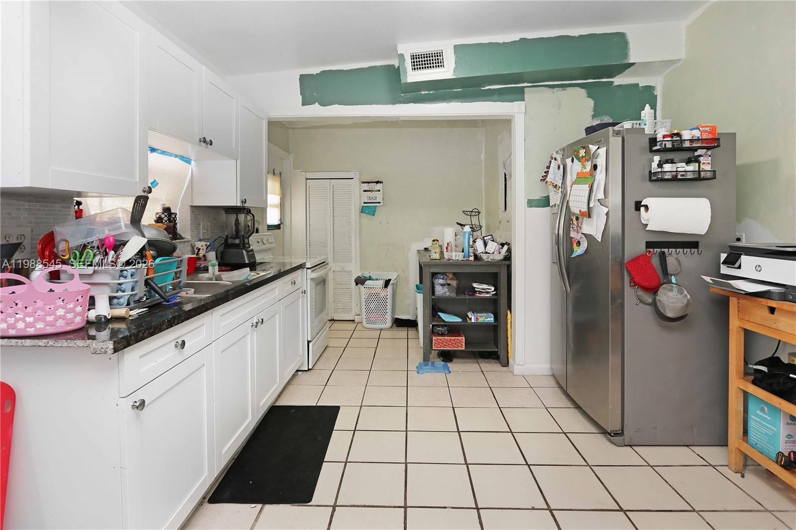 528 East 10th Street Hialeah, FL 33010 - Photo 8 of 13 a kitchen with stainless steel appliances a sink and cabinets