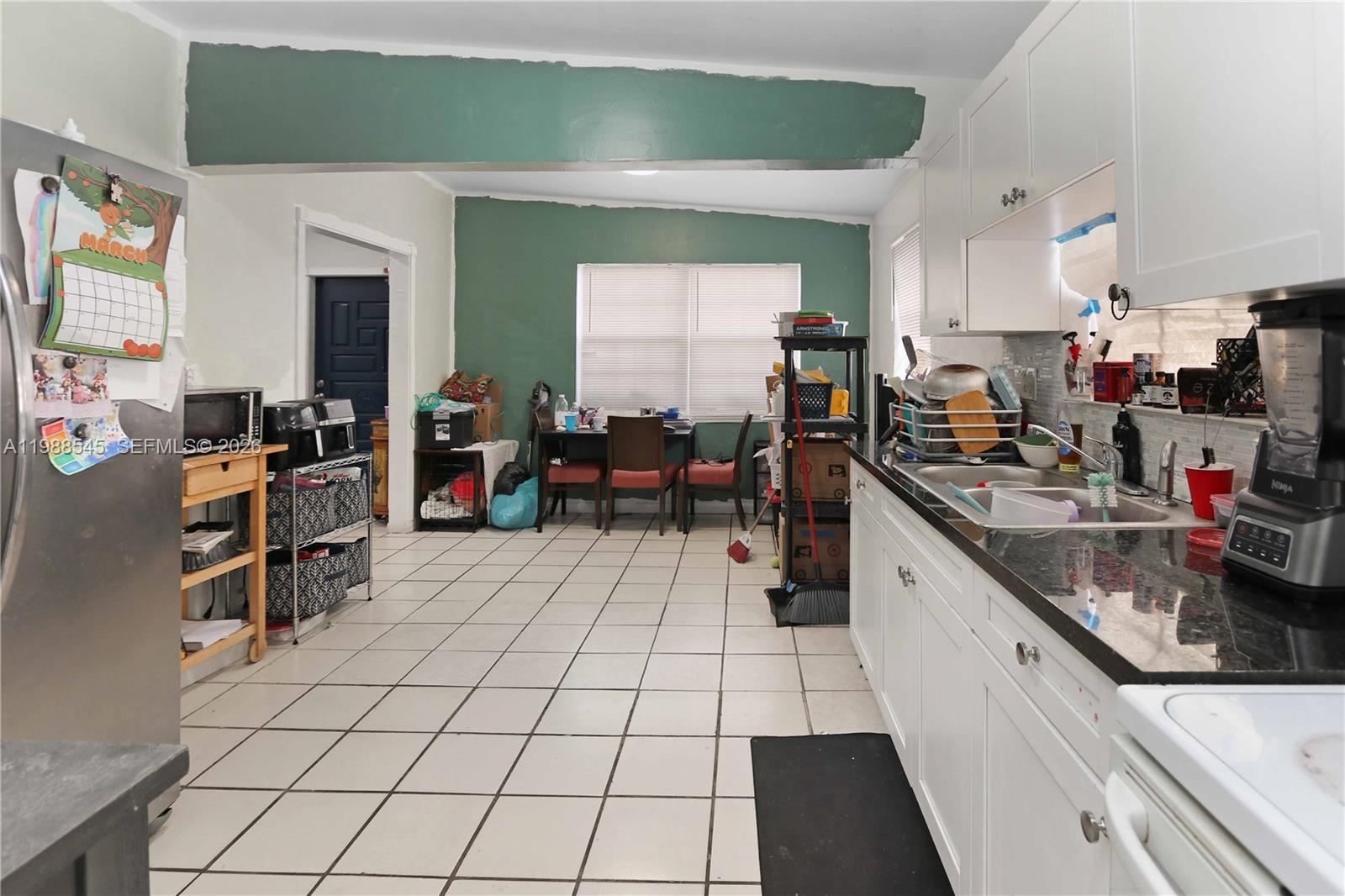 528 East 10th Street Hialeah, FL 33010 - Photo 9 of 13 a large white kitchen with lots of appliances a sink and cabinets
