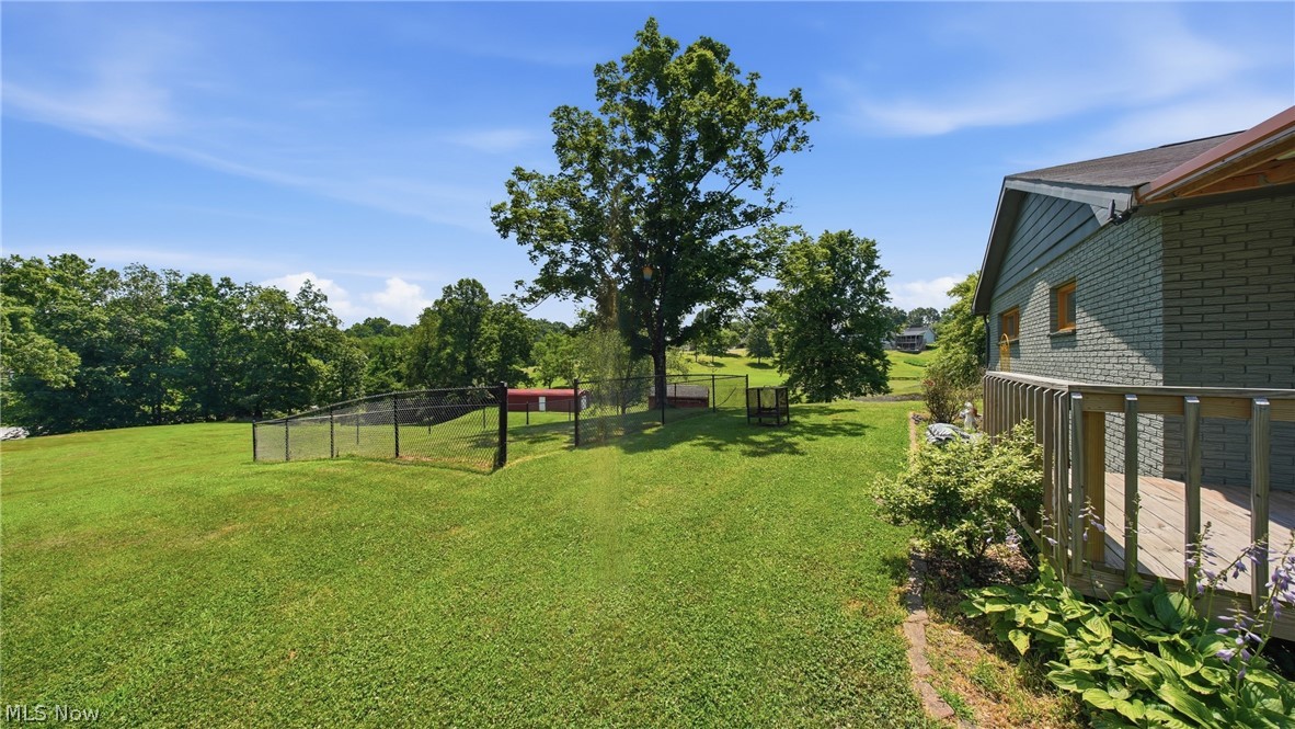 89 Dagg Road Parkersburg, WV 26101 - Photo 38 of 45 Expansive green lawn featuring a black chain-link fence enclosure