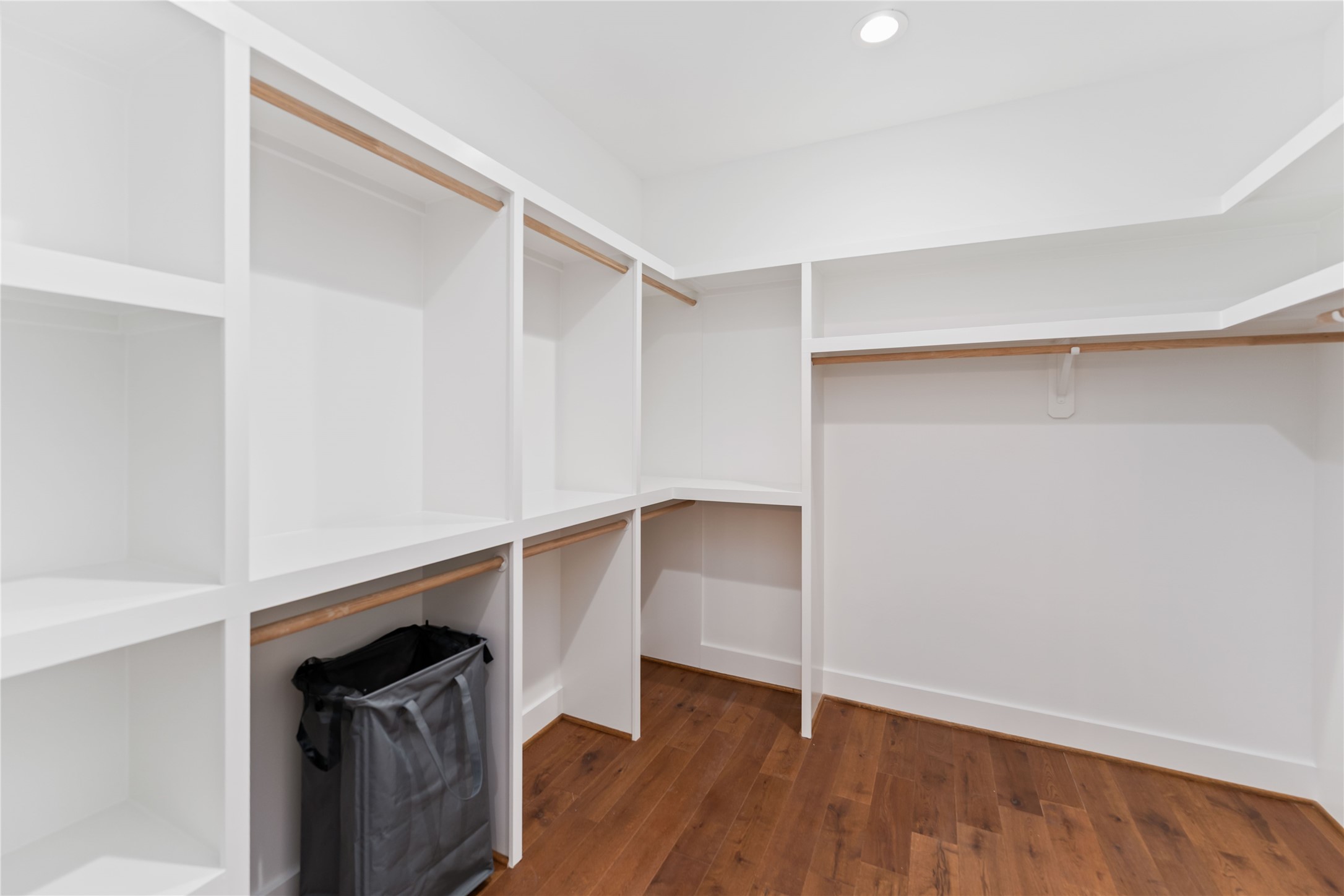 3040 Webster Street Houston, TX 77004 - Photo 12 of 18 a view of walk in closet with wooden floor