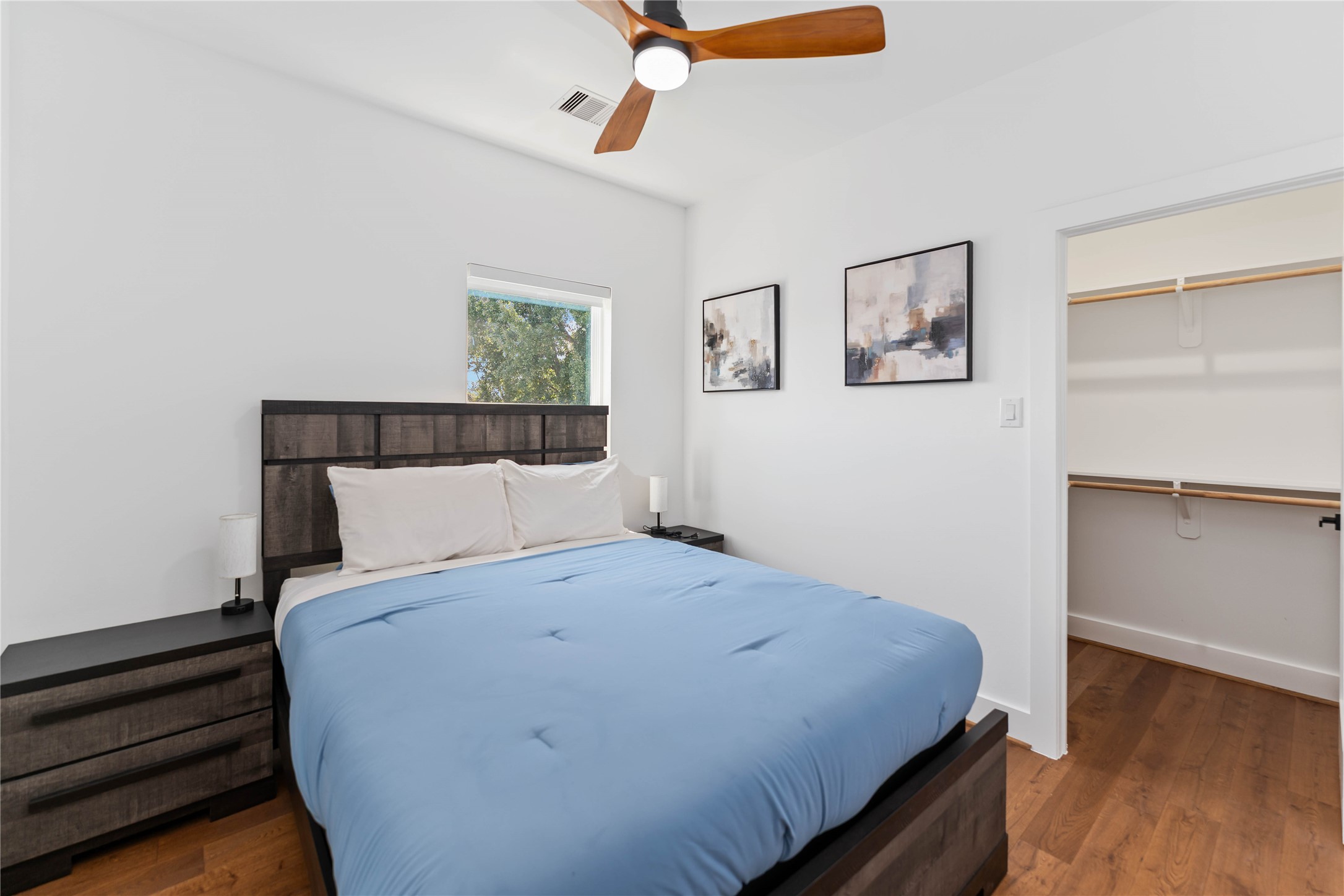 3040 Webster Street Houston, TX 77004 - Photo 14 of 18 a bedroom with a bed and wooden floor