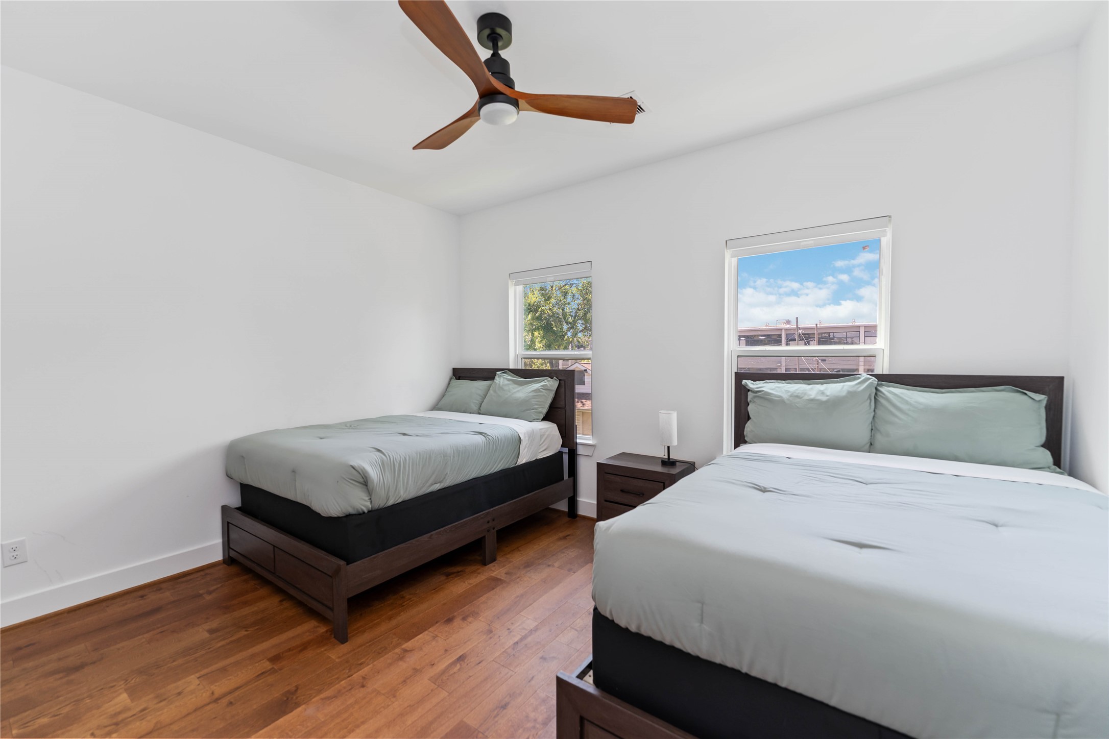 3040 Webster Street Houston, TX 77004 - Photo 15 of 18 a bedroom with a bed two lamps and a table