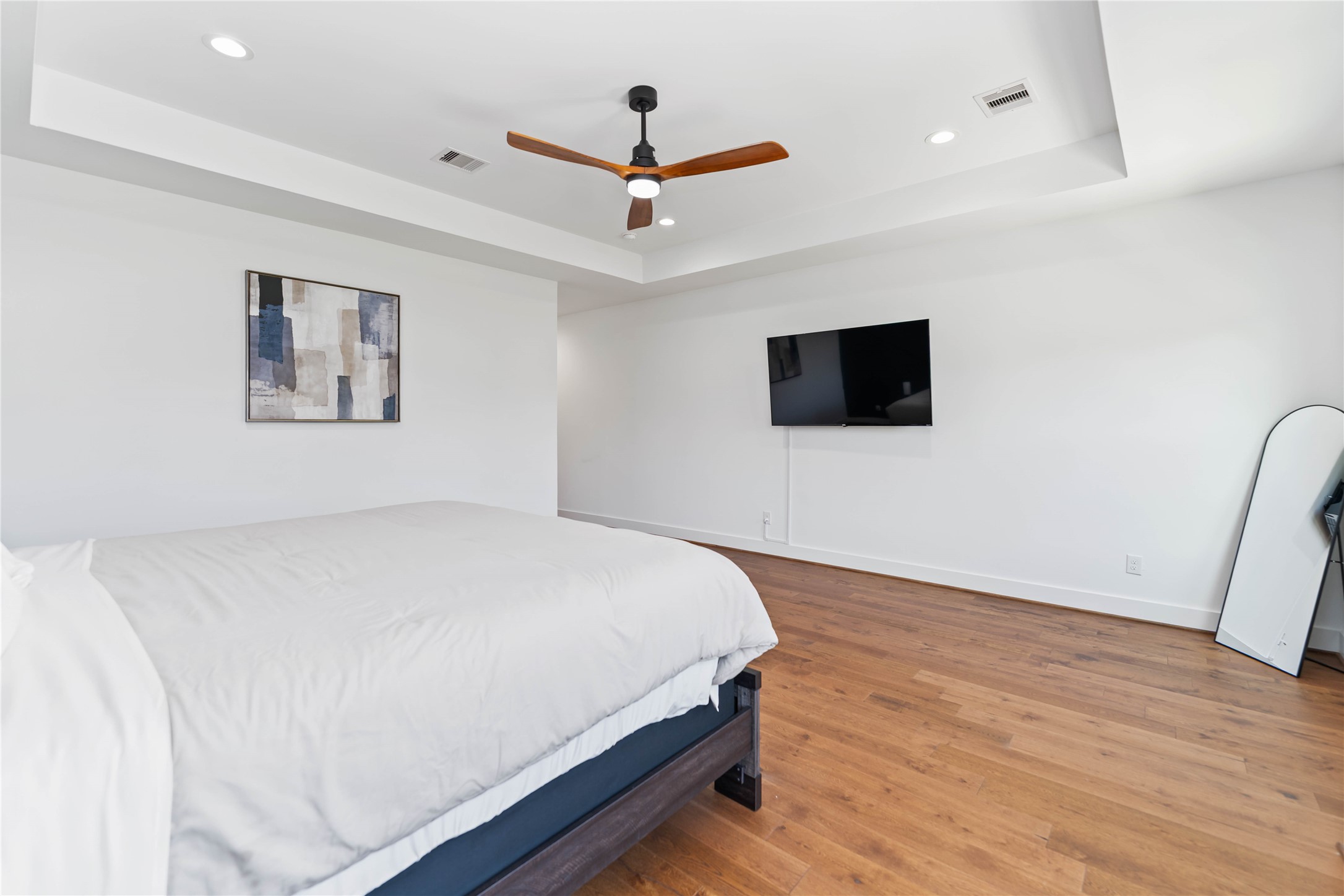 3040 Webster Street Houston, TX 77004 - Photo 8 of 18 a bedroom with a bed and a flat screen tv