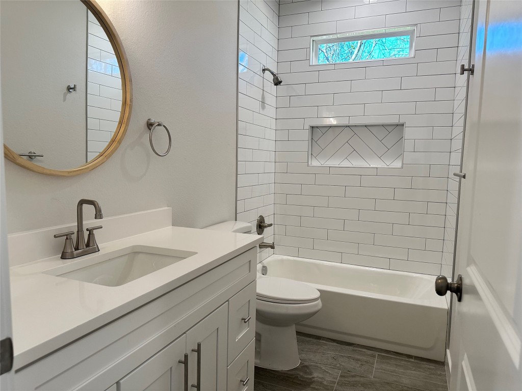 1115 Neches Street Lockhart, TX 78644 - Photo 15 of 22 a bathroom with a sink a toilet and shower