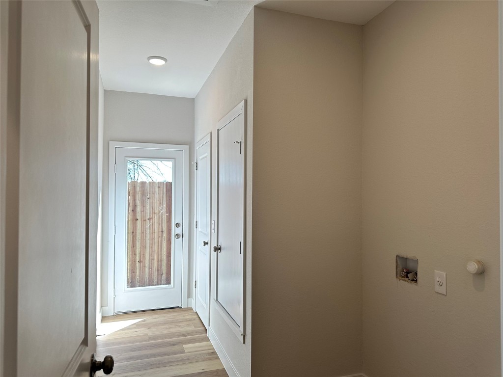 1115 Neches Street Lockhart, TX 78644 - Photo 20 of 22 a view of a hallway with wooden floor