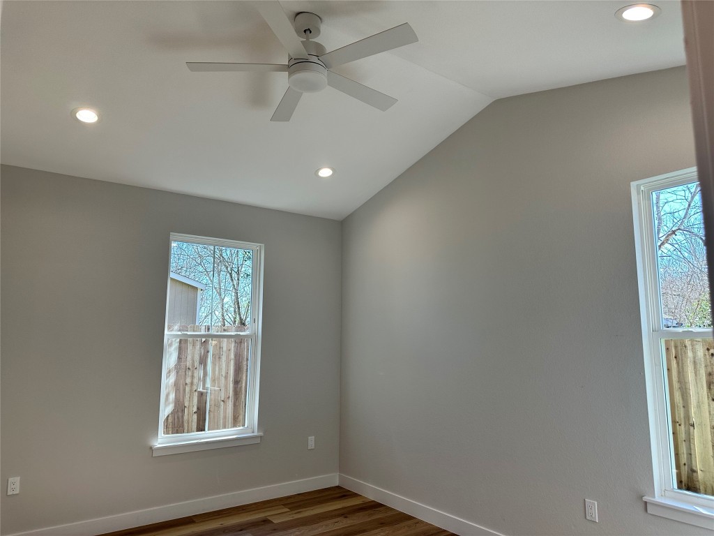 1115 Neches Street Lockhart, TX 78644 - Photo 8 of 22 an empty room with windows and fan