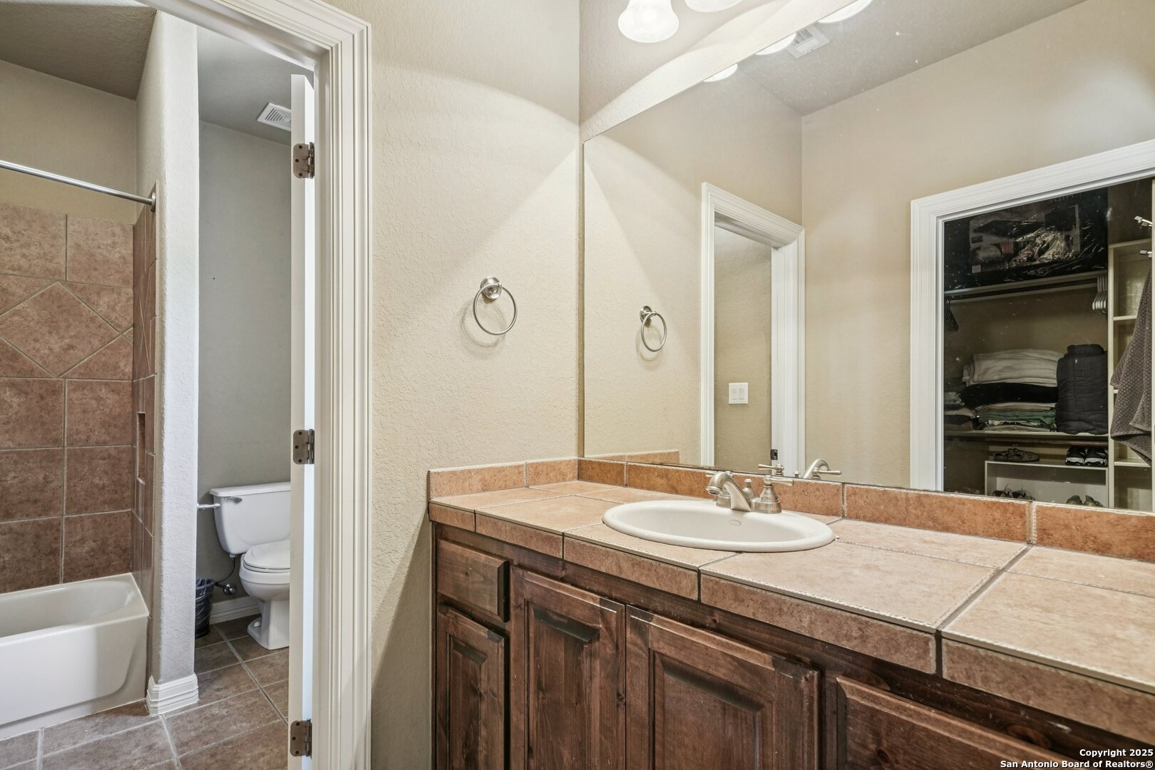 718 Ruidosa Downs Helotes, TX 78023 - Photo 27 of 50 a bathroom with a sink and a mirror