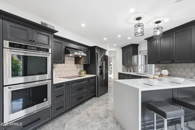 a large white kitchen with a large window