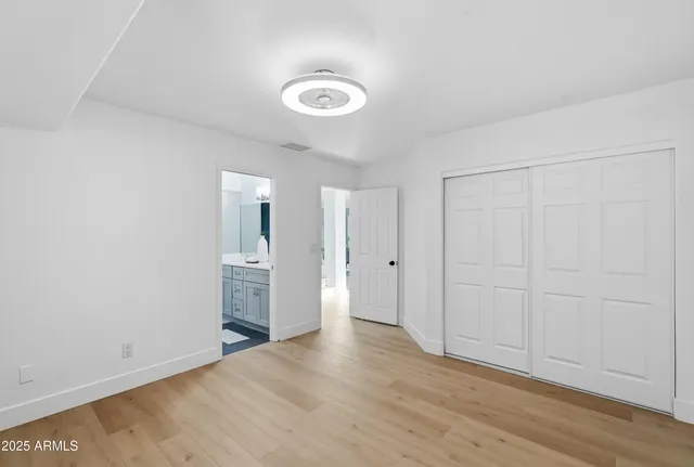 a bedroom with a large bed and a large window