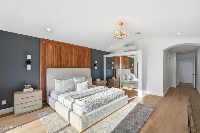 a bathroom with a double vanity sink a mirror and a bathtub