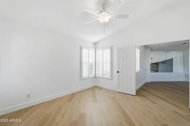 a bathroom with a double vanity sink a mirror and bathtub