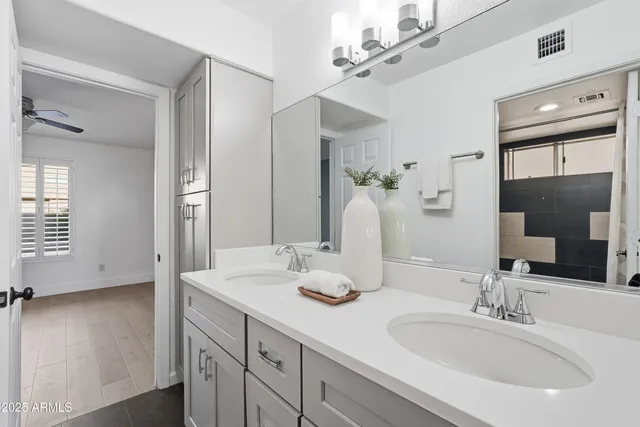 a view of a bathroom with a sink and mirror