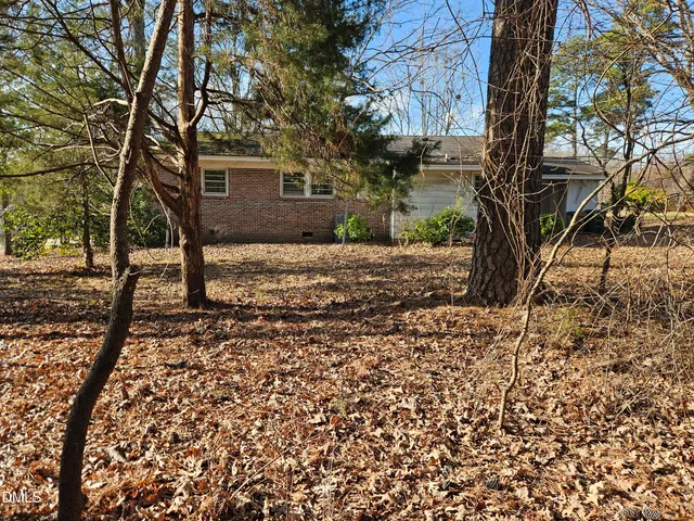 a view of a backyard with large trees