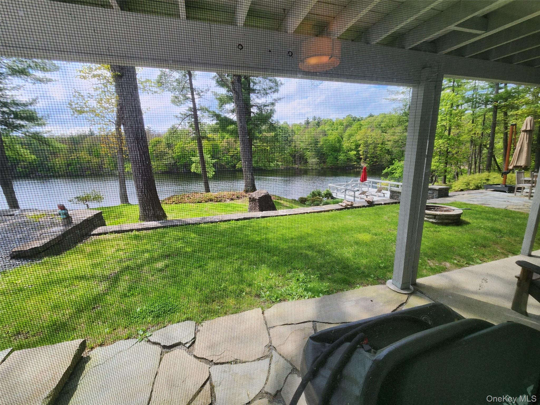 53 Lake Pleasant Road Staatsburg, NY 12580 - Photo 33 of 34 a view of a patio with a table chairs and a backyard