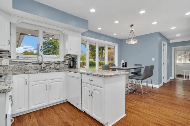 a kitchen with sink cabinets and wooden floor