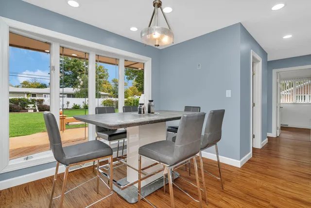 a view of a dining room with furniture window and wooden floor