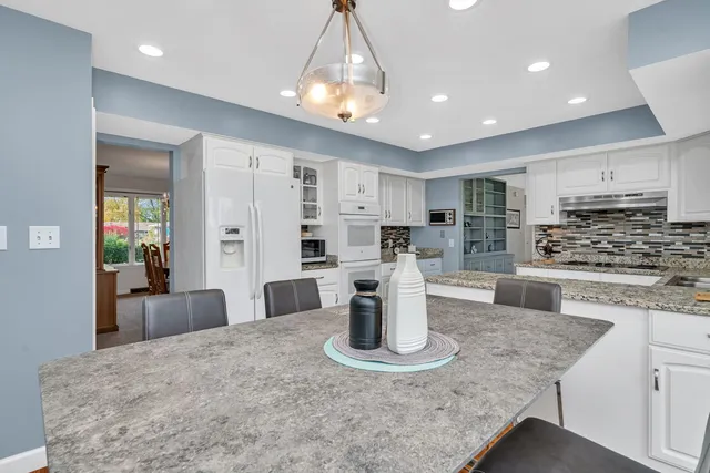 a kitchen with refrigerator and stove