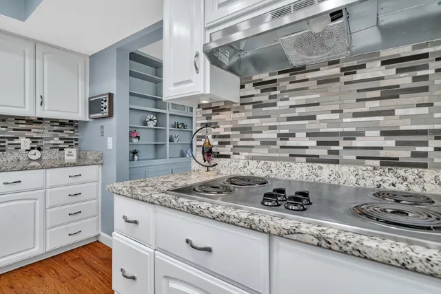 a kitchen with a stove and cabinets