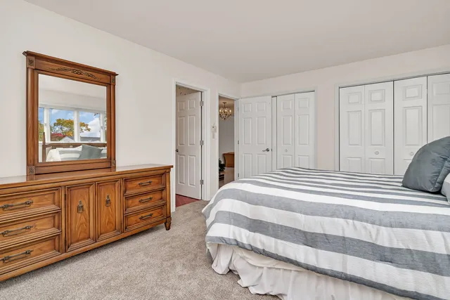 a spacious bedroom with a bed and a window