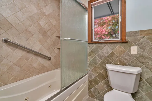 a bathroom with a toilet and a shower
