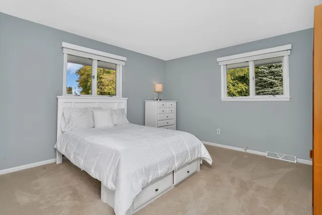 a bedroom with a bed and a window