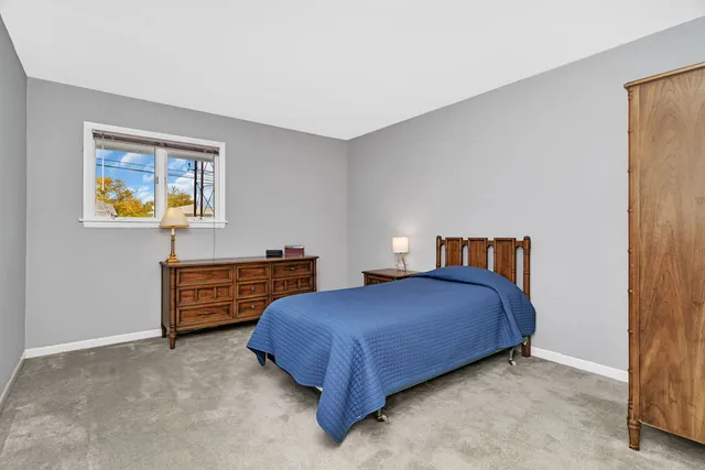 a bedroom with a bed and a table