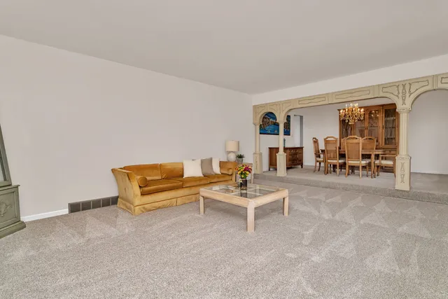 a bedroom with furniture and a lamp on table
