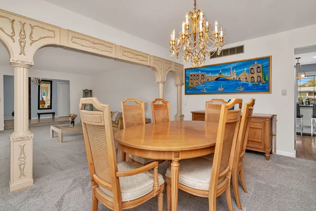 a view of a dining room with furniture and chandelier