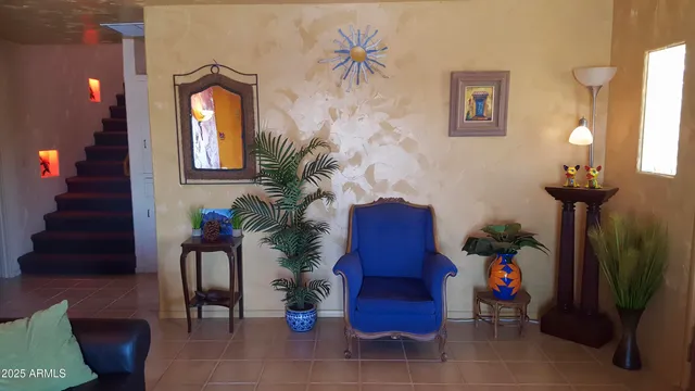 a view of a livingroom with furniture and a potted plant