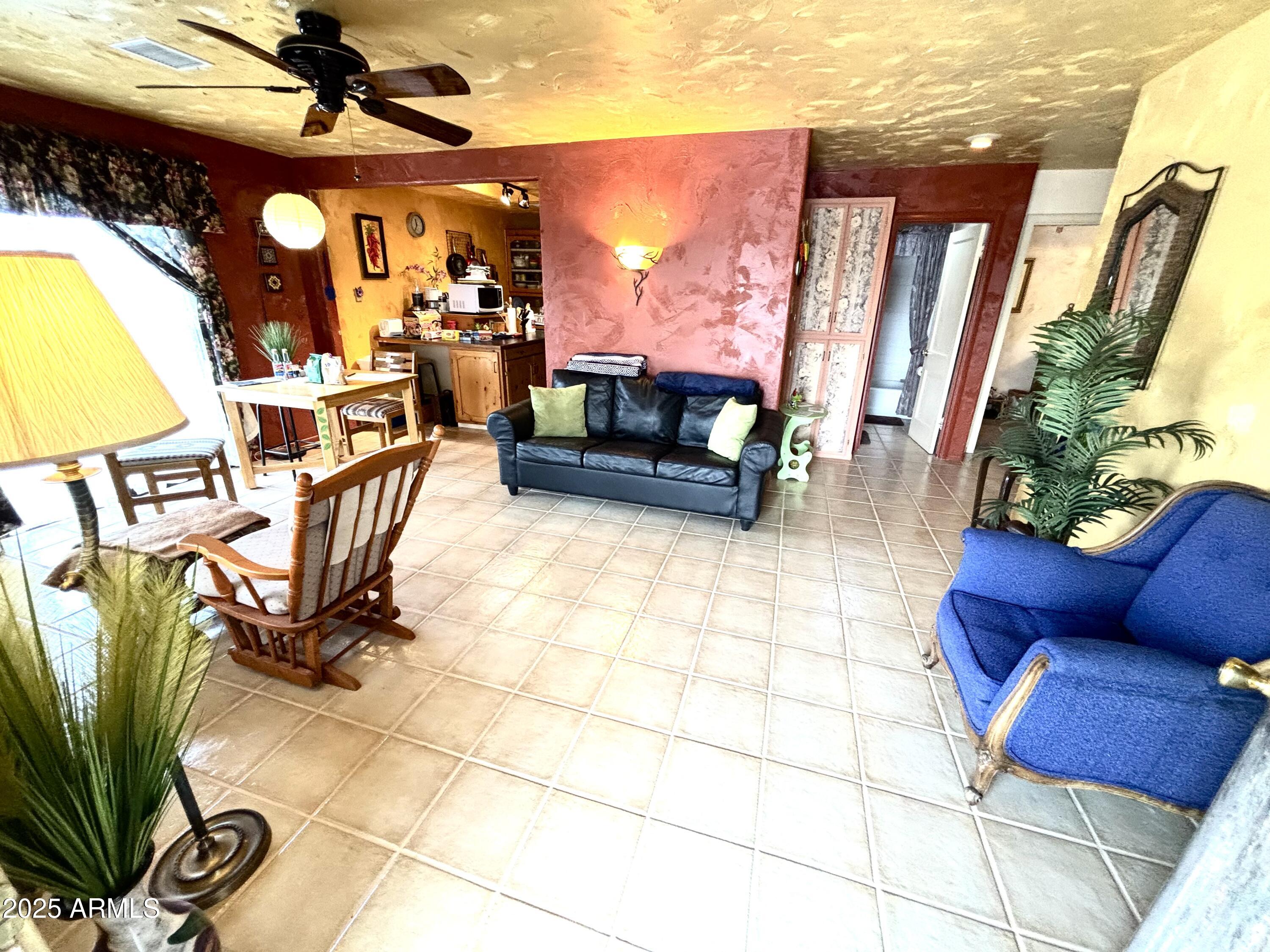 2860 North Elliott Road Ajo, AZ 85321 - Photo 12 of 35 a view of a livingroom with furniture and a potted plant