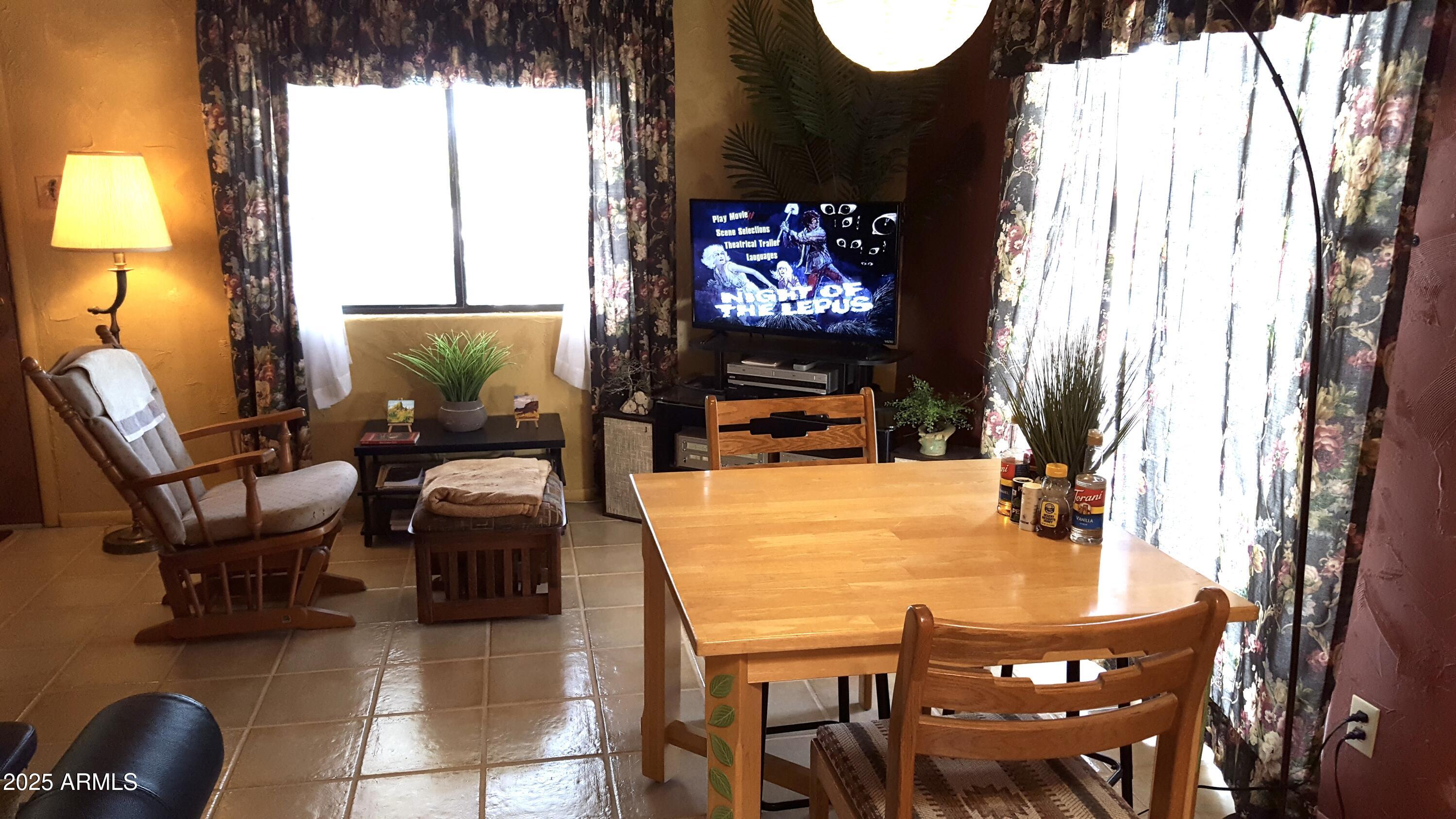 2860 North Elliott Road Ajo, AZ 85321 - Photo 15 of 35 a dining room with furniture and a flat screen tv