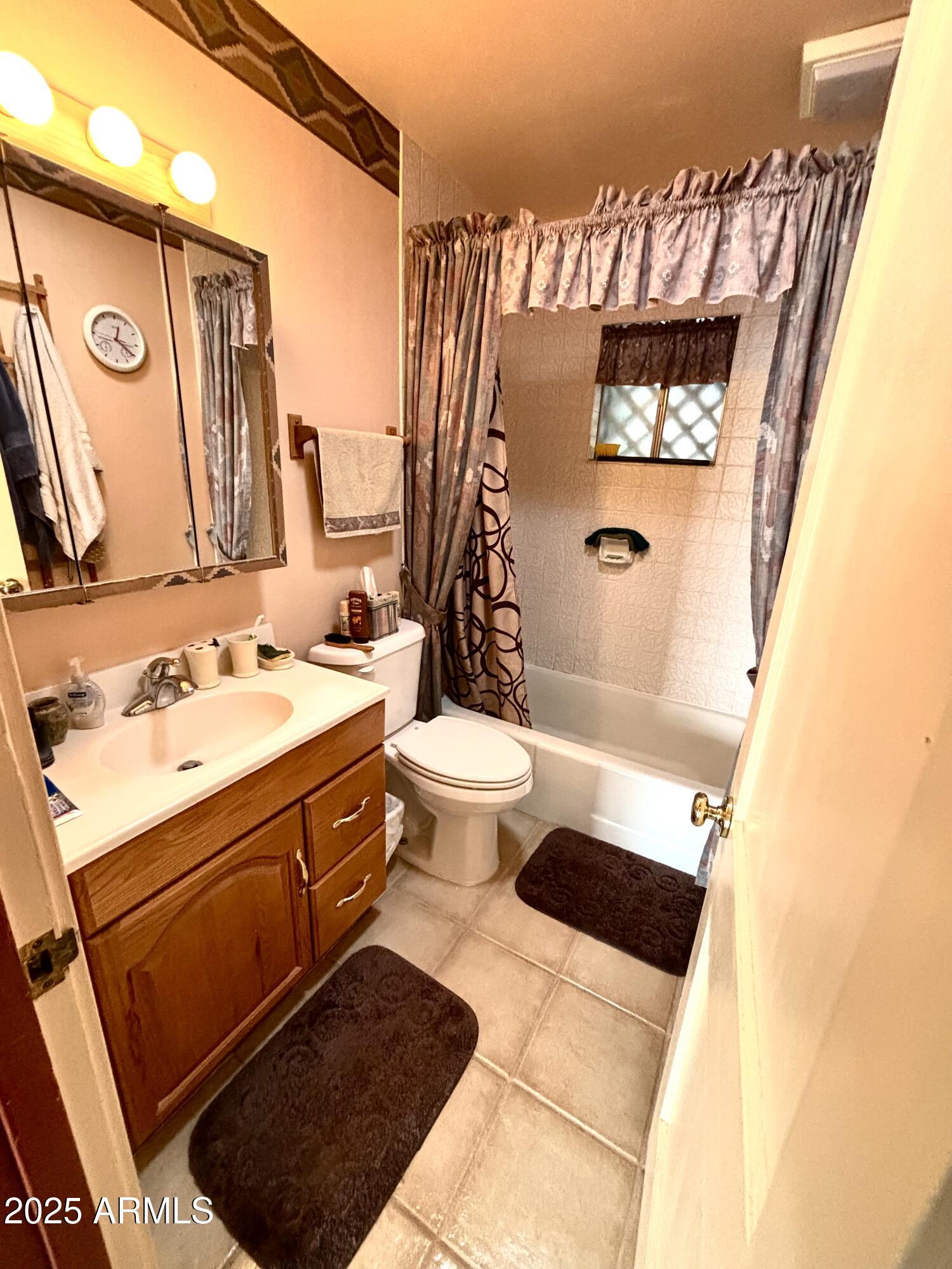 2860 North Elliott Road Ajo, AZ 85321 - Photo 17 of 35 a bathroom with a sink a toilet and shower