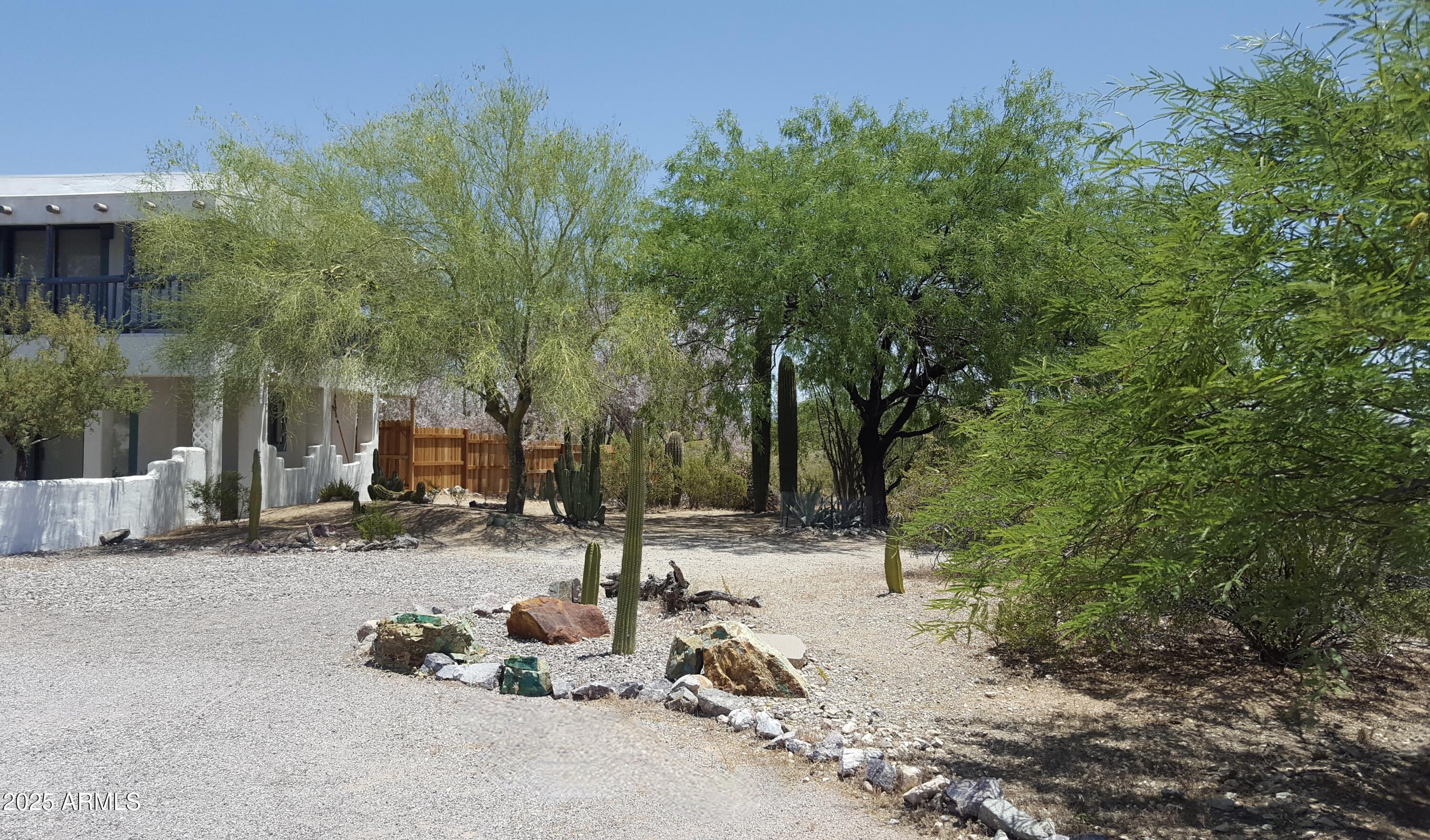 2860 North Elliott Road Ajo, AZ 85321 - Photo 27 of 35 a backyard of a house with table and chairs and potted plants