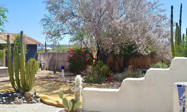 a view of a garden with an outdoor seating