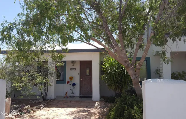 a view of a backyard with sitting area