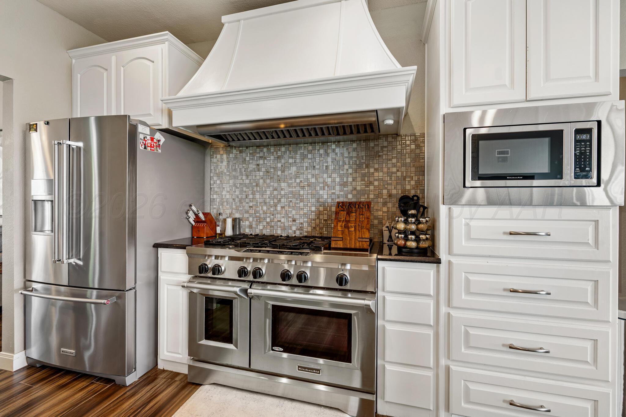 8901 Red Wing Road Amarillo, TX 79119 - Photo 14 of 66 a kitchen with stainless steel appliances and cabinets