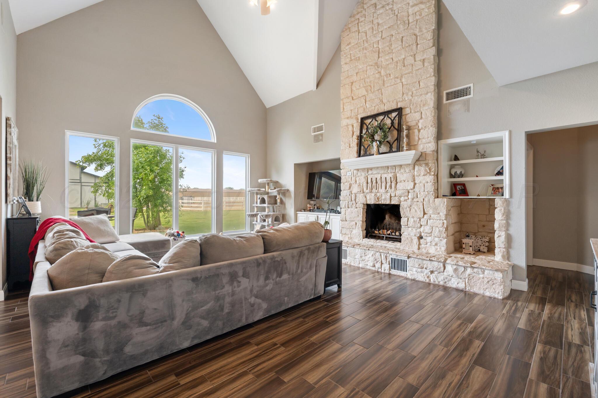 8901 Red Wing Road Amarillo, TX 79119 - Photo 20 of 66 a living room with furniture and a fireplace