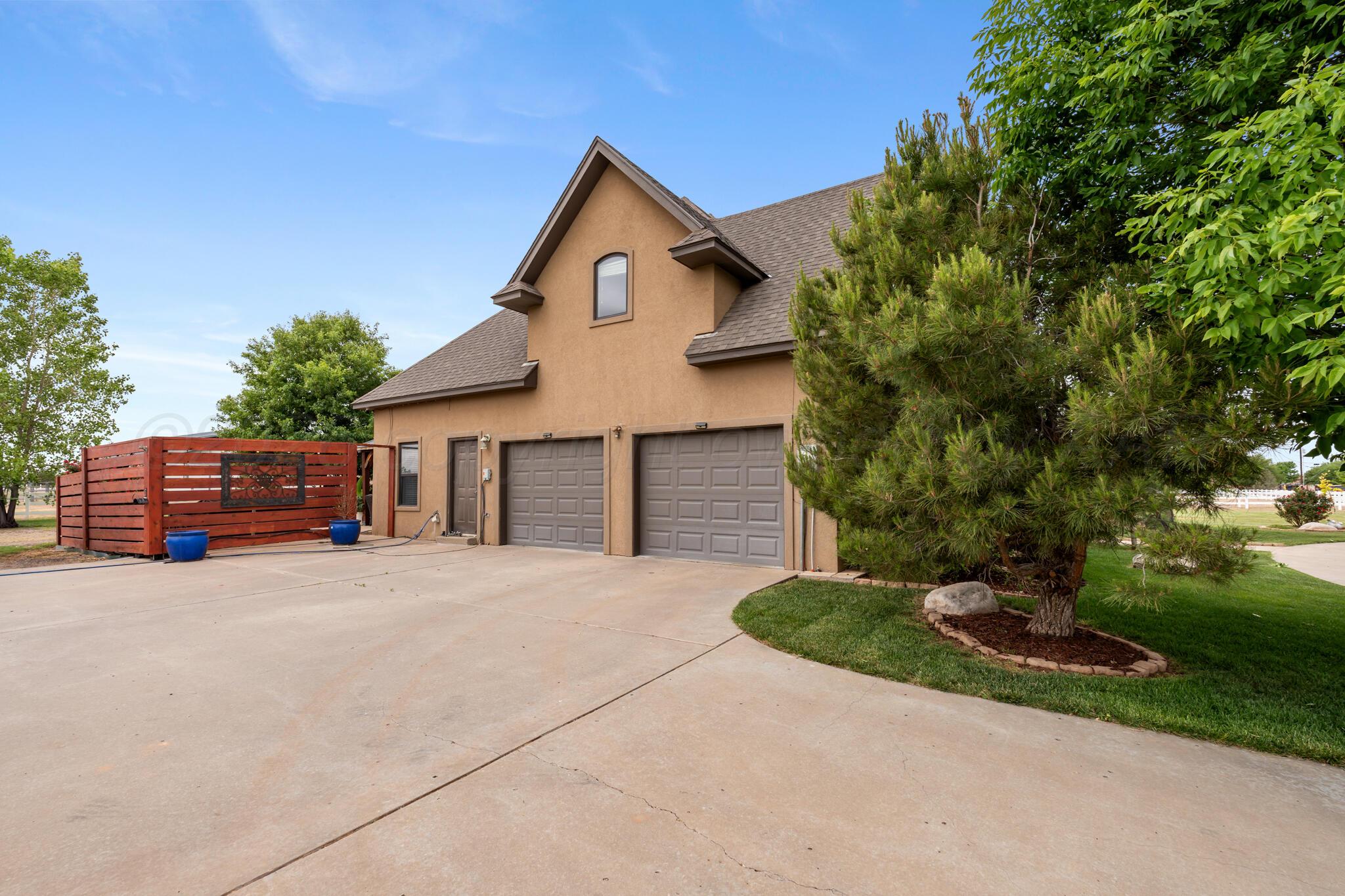 8901 Red Wing Road Amarillo, TX 79119 - Photo 36 of 66 a front view of a house with a yard and garage