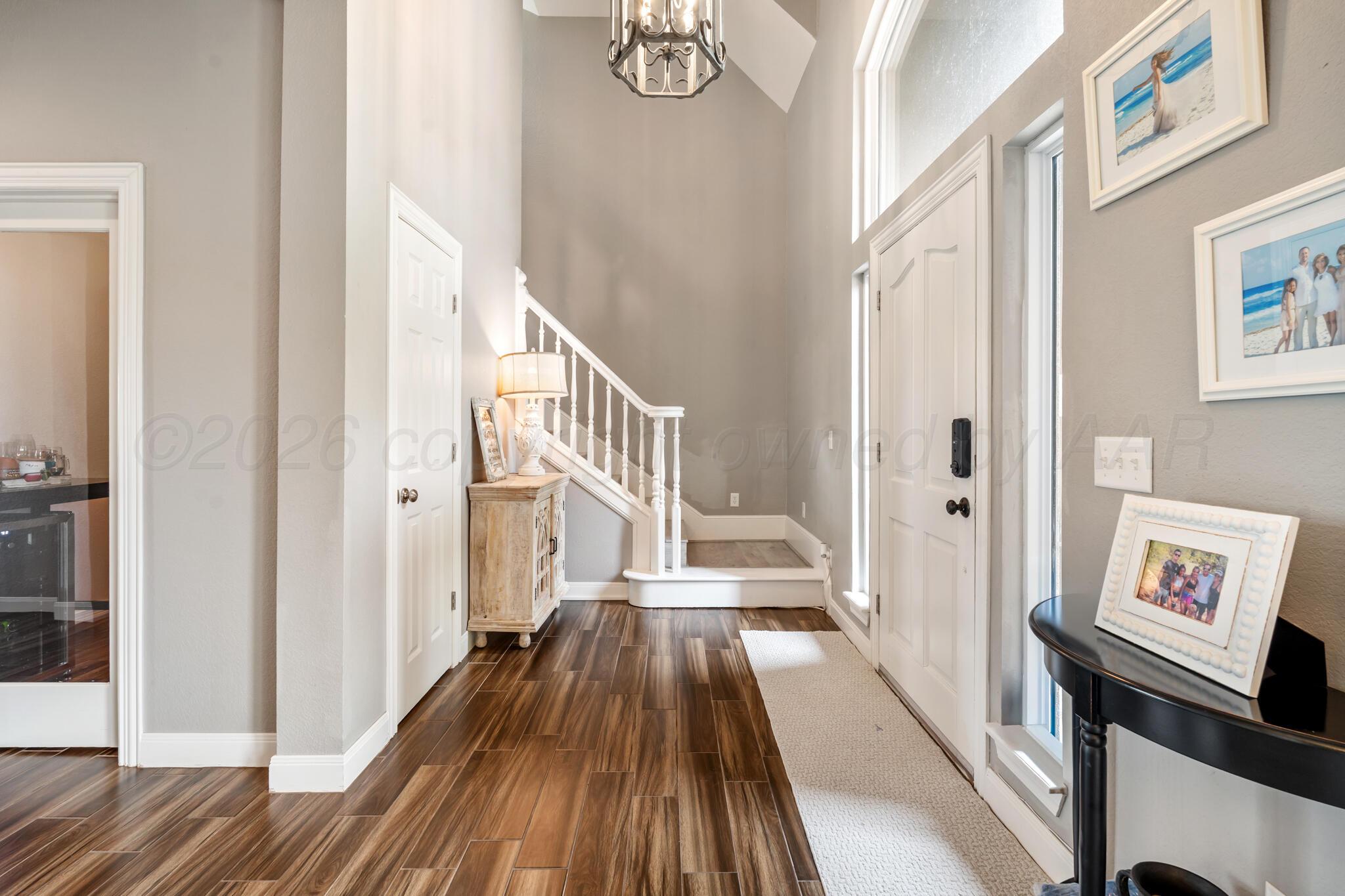 8901 Red Wing Road Amarillo, TX 79119 - Photo 9 of 66 a view of a hallway with wooden floor and staircase