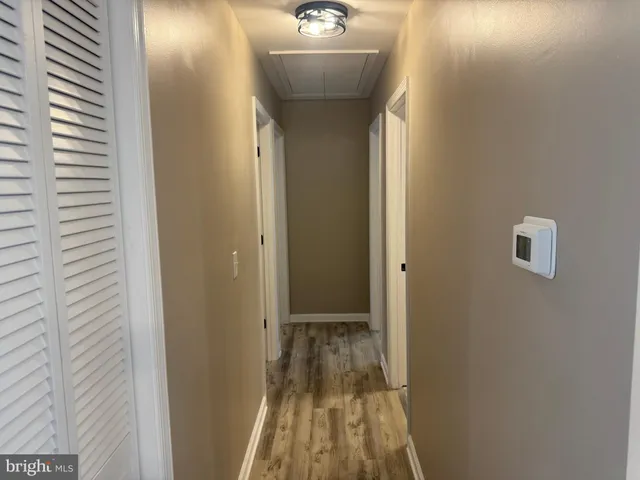 a view of a bathroom with a sink and wooden floor