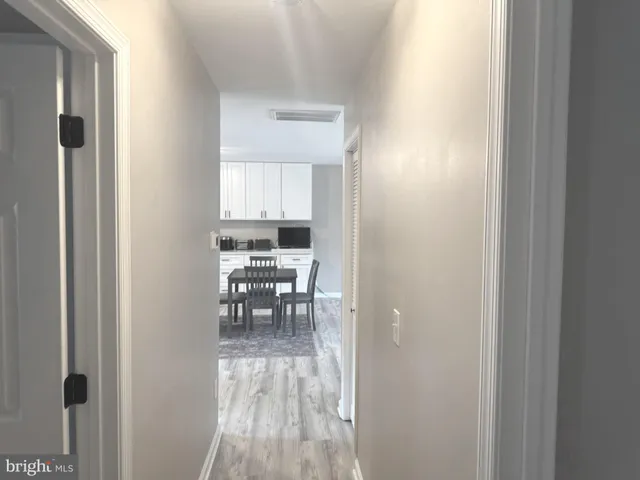 a view of a room that has a bed and a table in it