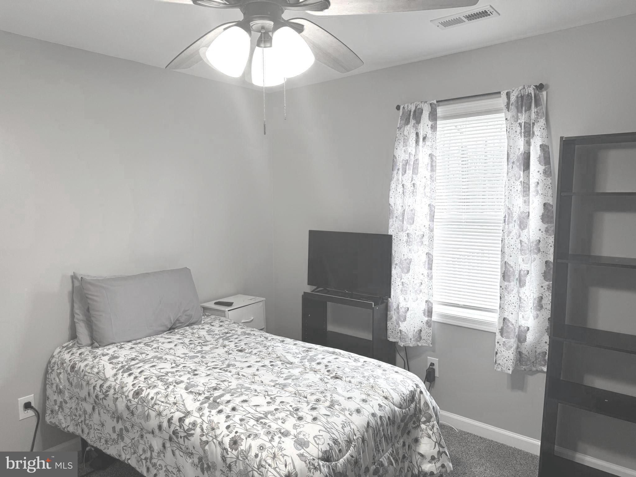 32201 Johnson Road Salisbury, MD 21804 - Photo 17 of 50 a bedroom with a bed and a window