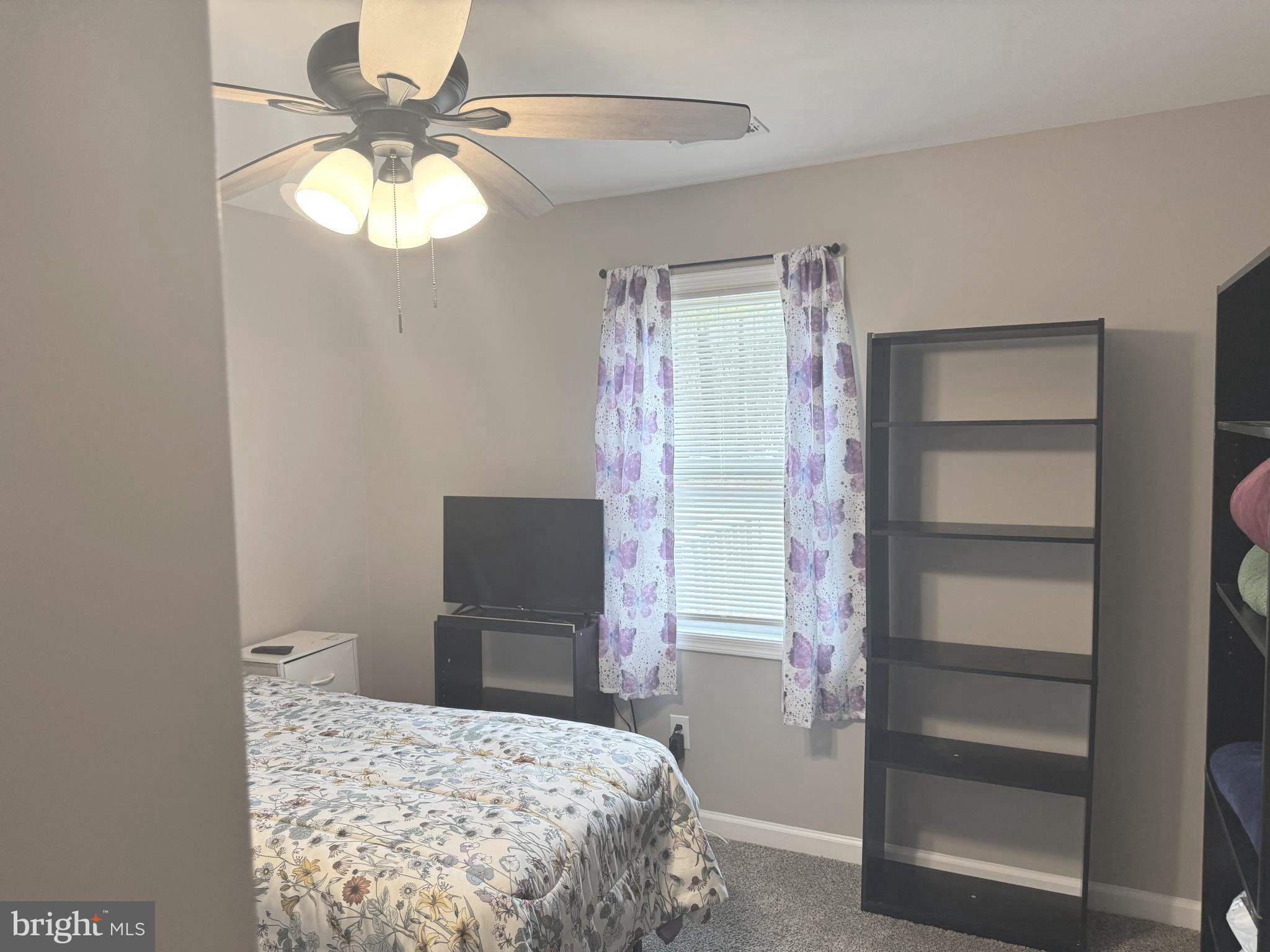 32201 Johnson Road Salisbury, MD 21804 - Photo 18 of 50 a bedroom with a bed and a chandelier