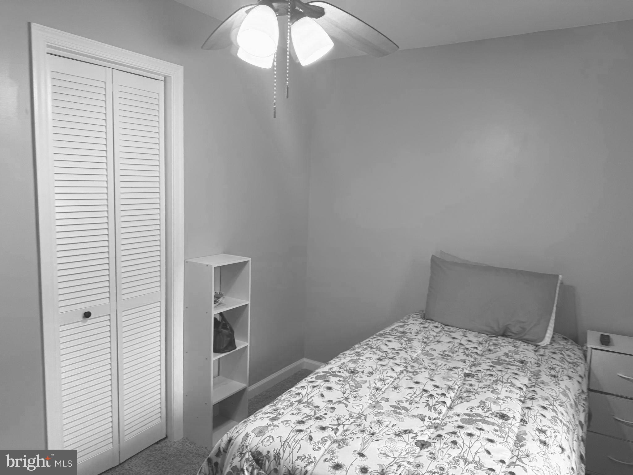 32201 Johnson Road Salisbury, MD 21804 - Photo 19 of 50 a bedroom with a bed and a chandelier