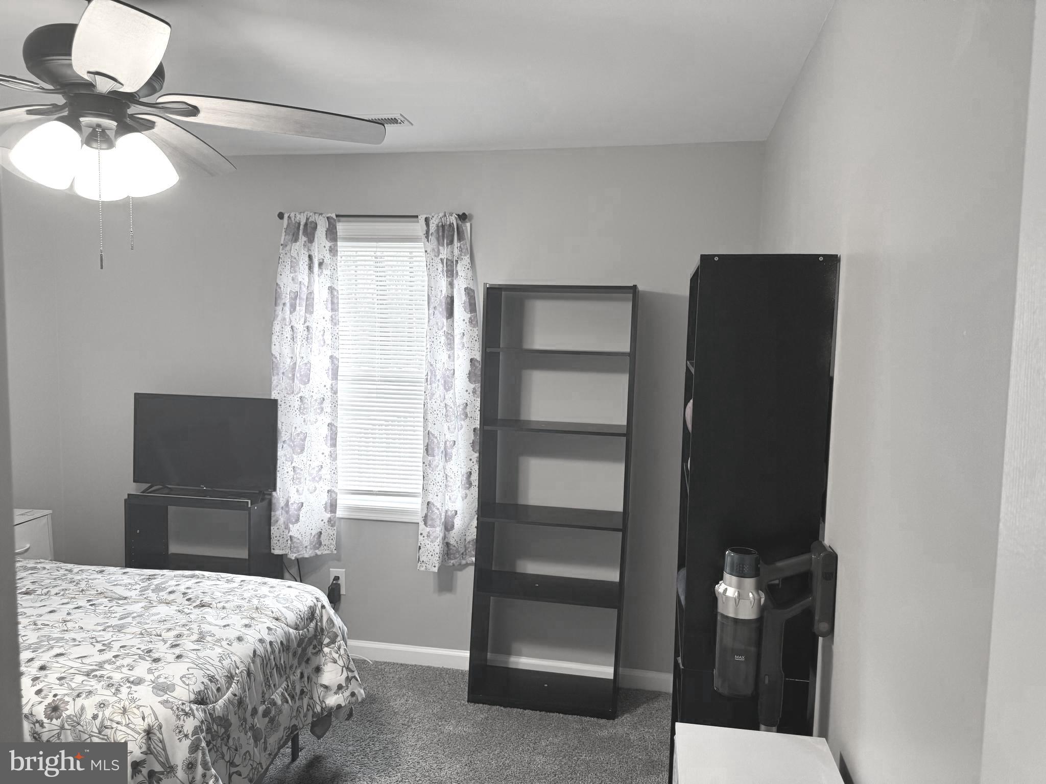 32201 Johnson Road Salisbury, MD 21804 - Photo 21 of 50 a bedroom with a bed and a chandelier