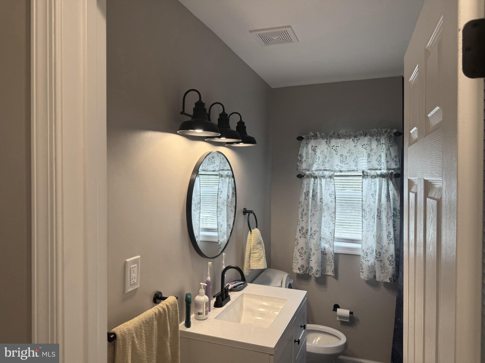 32201 Johnson Road Salisbury, MD 21804 - Photo 25 of 50 a bathroom with a sink and a mirror